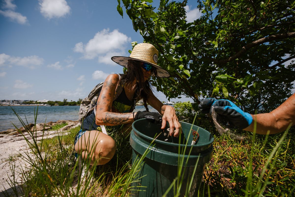 A Miami Waterkeeper volunteer collecting debris along the shoreline